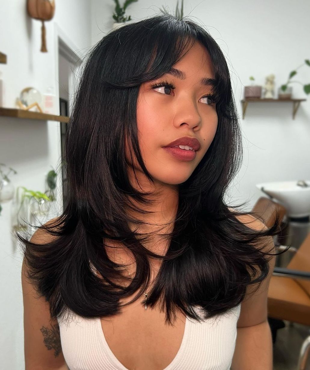 Heavily Layered Blowout Hair with Soft Curtain Bangs