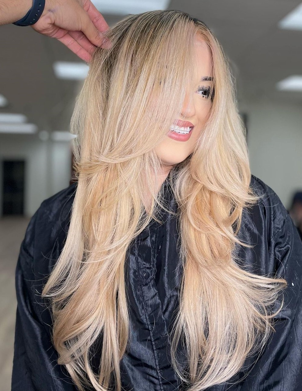 Long Blonde Layered Haircut with Dark Roots