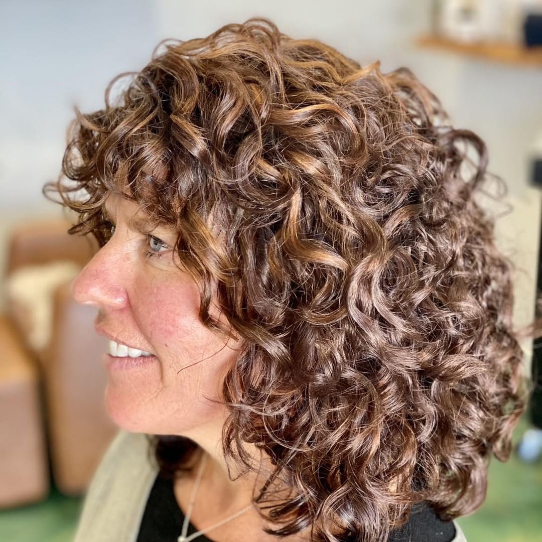 Rezo Cut with Bangs on Mature Woman with Shiny Curly Hair