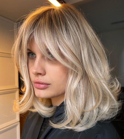 Blonde Collarbone Haircut with Curtain Bangs