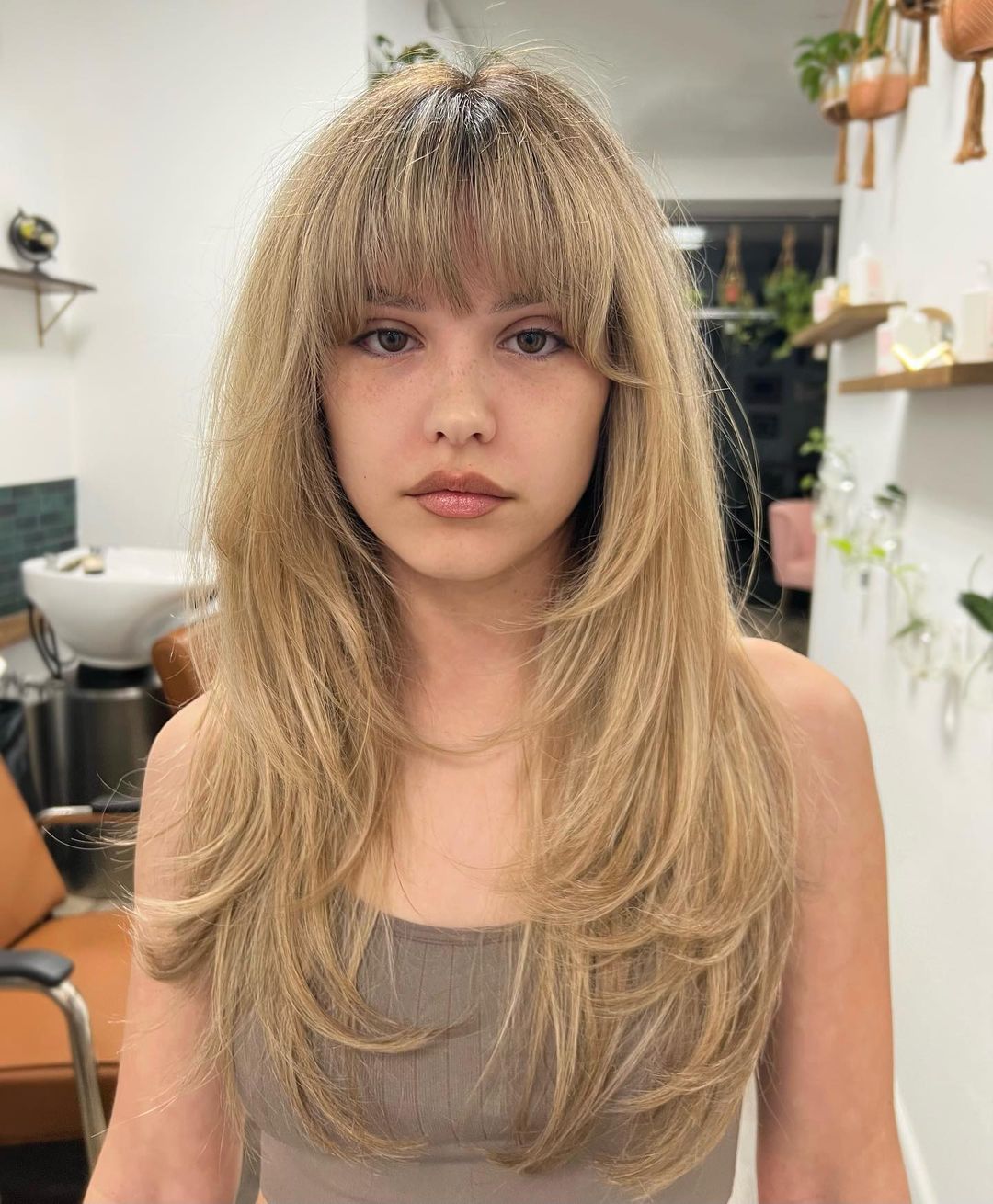 Blonde Hair with Long Feathered Layers and Thick Bangs