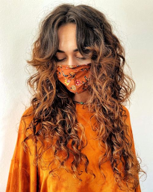 Long Highlighted Curly Hair with Curtain Bangs